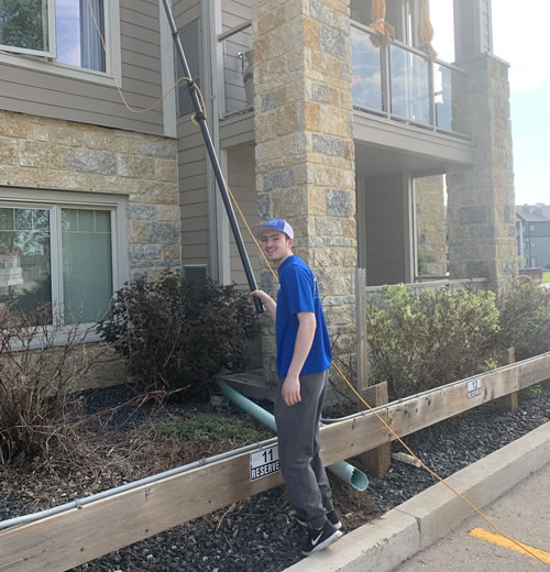 Insight Service Solutions Technician Washing A Two Story Home.